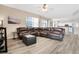 Spacious living room featuring hardwood floors, a comfortable sofa, and lots of natural light at 1751 Split Fork Dr, Oldsmar, FL 34677