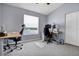 Office space with gray walls and carpet, two workstations, and a window for natural light at 1751 Split Fork Dr, Oldsmar, FL 34677