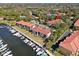 Aerial view capturing a community with boat docks, waterfront access and lush surroundings at 1800 Mariner Dr # 2, Tarpon Springs, FL 34689