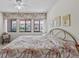 Bright bedroom features large windows, neutral walls, ceiling fan, and comfortable, relaxing atmosphere at 1800 Mariner Dr # 2, Tarpon Springs, FL 34689