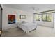 Cozy bedroom with bright windows, a ceiling fan, and colorful art at 1800 Mariner Dr # 2, Tarpon Springs, FL 34689