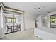 Bedroom featuring neutral carpet, a ceiling fan, and access to the sunroom at 1800 Mariner Dr # 2, Tarpon Springs, FL 34689
