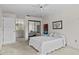 Bedroom features an ensuite bath, mirrored closet, and standard ceiling fan at 1800 Mariner Dr # 2, Tarpon Springs, FL 34689