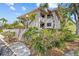 An angled view showcasing the two-story condo's landscaping, balconies, and architectural details at 1800 Mariner Dr # 2, Tarpon Springs, FL 34689