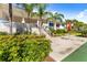 Beautiful exterior featuring lush landscaping, a patio, and charming architectural details at 1800 Mariner Dr # 2, Tarpon Springs, FL 34689