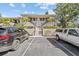 A bright two-story condo featuring a red tile roof, landscaped grounds, and convenient parking at 1800 Mariner Dr # 2, Tarpon Springs, FL 34689