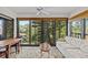 Inviting sunroom features neutral color palette, ceiling fan, and large windows with a lovely view at 1800 Mariner Dr # 2, Tarpon Springs, FL 34689