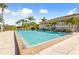 Inviting swimming pool with deck chairs, surrounded by lush greenery for relaxation and recreation at 1800 Mariner Dr # 2, Tarpon Springs, FL 34689