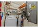 Utility room featuring a washer, dryer, hot water tank, and extra shelving at 1800 Mariner Dr # 2, Tarpon Springs, FL 34689