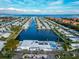 Stunning aerial view of waterfront community homes, featuring a pool, clubhouse and scenic water views at 18675 Us Highway 19 N # 140, Clearwater, FL 33764