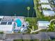 Aerial view of community pool and spa with waterfront access and palm trees at 18675 Us Highway 19 N # 140, Clearwater, FL 33764