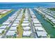 Expansive aerial view of waterfront community, highlighting canal-front homes with boat docks and easy ocean access at 18675 Us Highway 19 N # 140, Clearwater, FL 33764