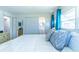 Bright bedroom featuring wood floors, sliding closet doors, and an ensuite bathroom for convenience and privacy at 18675 Us Highway 19 N # 140, Clearwater, FL 33764