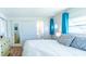 Bright bedroom featuring wood floors, sliding closet doors, and an ensuite bathroom for convenience and privacy at 18675 Us Highway 19 N # 140, Clearwater, FL 33764