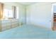 Bright bedroom with dresser, sliding door closet, and cozy blue bed at 18675 Us Highway 19 N # 140, Clearwater, FL 33764
