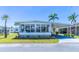 Charming home features a covered carport, quaint landscaping, and an inviting sunroom, perfect for enjoying the sunny Florida weather at 18675 Us Highway 19 N # 140, Clearwater, FL 33764
