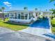 Charming single-story home featuring a covered parking area, enclosed patio, and well-maintained landscaping at 18675 Us Highway 19 N # 140, Clearwater, FL 33764