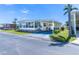 Charming home features a covered carport, quaint landscaping, and an inviting sunroom, perfect for enjoying the sunny Florida weather at 18675 Us Highway 19 N # 140, Clearwater, FL 33764