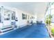 Inviting home exterior with a carport, patio seating, lush landscaping, and charming curb appeal at 18675 Us Highway 19 N # 140, Clearwater, FL 33764