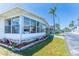 The sunroom is a featured part of the exterior of this home, with great natural light and a low walled foundation with brick embellishments at 18675 Us Highway 19 N # 140, Clearwater, FL 33764