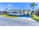 Charming home features a covered carport, quaint landscaping, and an inviting sunroom, perfect for enjoying the sunny Florida weather at 18675 Us Highway 19 N # 140, Clearwater, FL 33764