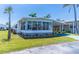 Charming home features a covered carport, quaint landscaping, and an inviting sunroom, perfect for enjoying the sunny Florida weather at 18675 Us Highway 19 N # 140, Clearwater, FL 33764