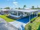 Charming single-level home with a spacious carport and a beautifully landscaped yard at 18675 Us Highway 19 N # 140, Clearwater, FL 33764