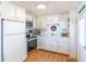 Bright kitchen featuring white cabinets, modern appliances, wood-look floors, and fresh clean appeal at 18675 Us Highway 19 N # 140, Clearwater, FL 33764