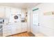 Bright kitchen with white cabinets, stylish hardware, and a convenient door leading to the outside at 18675 Us Highway 19 N # 140, Clearwater, FL 33764