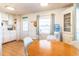 Cozy kitchen area featuring white cabinetry, wood floors, and eat-in dining set at 18675 Us Highway 19 N # 140, Clearwater, FL 33764