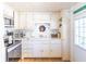 Charming kitchen featuring white cabinets, stainless steel appliances, and a bright, welcoming ambiance at 18675 Us Highway 19 N # 140, Clearwater, FL 33764