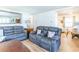 Comfortable living room with reclining sofas, wood floors, and plenty of natural light at 18675 Us Highway 19 N # 140, Clearwater, FL 33764