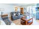 Spacious living room with comfortable sofas, a cozy sunroom, and wood-look floors at 18675 Us Highway 19 N # 140, Clearwater, FL 33764