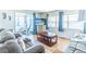 Open-concept living room with sliding glass doors, wood-look floors, and ocean view TV at 18675 Us Highway 19 N # 140, Clearwater, FL 33764