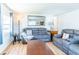 Bright living area featuring a plush gray sofa, wood floors, and a decorative mirror at 18675 Us Highway 19 N # 140, Clearwater, FL 33764