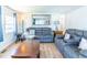 Bright living room with a gray sofa, wood floors and a decorative coffee table at 18675 Us Highway 19 N # 140, Clearwater, FL 33764