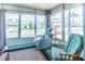 Inviting sunroom filled with sunlight, comfortable seating, and views of the neighborhood at 18675 Us Highway 19 N # 140, Clearwater, FL 33764