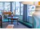 Inviting sunroom featuring seating, dining table, and views of the neighborhood at 18675 Us Highway 19 N # 140, Clearwater, FL 33764