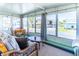 Cozy sunroom with views of the neighborhood and a comfortable seating area at 18675 Us Highway 19 N # 140, Clearwater, FL 33764