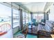 Bright sunroom featuring large windows, casual seating, and comfortable sofa for relaxing and entertaining guests at 18675 Us Highway 19 N # 140, Clearwater, FL 33764