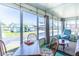 Bright sunroom featuring large windows, casual seating, and a comfortable spot for relaxing or entertaining guests at 18675 Us Highway 19 N # 140, Clearwater, FL 33764