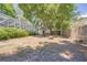 Spacious backyard featuring lush trees and a firepit, adjacent to the screened in pool area at 1916 River Crossing Dr, Valrico, FL 33596