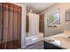 Neutral bathroom featuring a shower-tub combo with stylish curtain, a window, and modern vanity at 1916 River Crossing Dr, Valrico, FL 33596