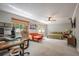 Spacious bedroom with a full-size bed, seating area, desk, and a ceiling fan at 1916 River Crossing Dr, Valrico, FL 33596