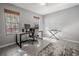 Bedroom setup with desk, computer, keyboard, and wood-look floors at 1916 River Crossing Dr, Valrico, FL 33596
