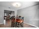 Cozy dining area with seating for four, perfect for intimate meals, with living area visible at 1916 River Crossing Dr, Valrico, FL 33596