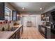 Spacious kitchen with dark cabinetry, stainless steel appliances, and view of dining room at 1916 River Crossing Dr, Valrico, FL 33596