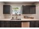 Kitchen featuring dark cabinets, stainless steel appliances, and natural light from the window at 1916 River Crossing Dr, Valrico, FL 33596