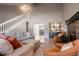 Bright, open-concept living space with neutral sofas and a fireplace and bar in background at 1916 River Crossing Dr, Valrico, FL 33596