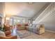 Inviting living room with large windows, a comfortable sofa, and a staircase leading upstairs at 1916 River Crossing Dr, Valrico, FL 33596